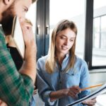 Professional woman showing man how he made a mistake