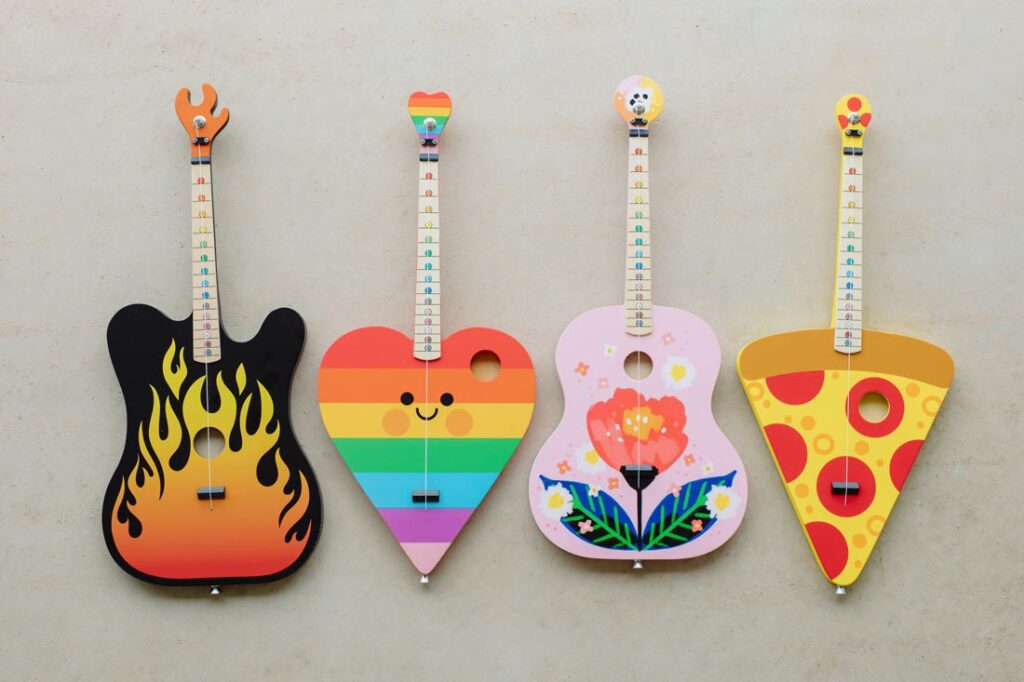 4 colorful one-string children's guitars that are part of the TinkerTar line created by Rockbridge Guitars' co-founder Brian Calhoun