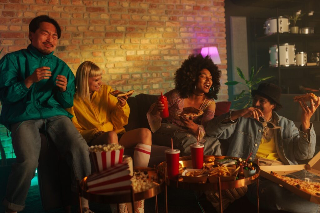 A group of friends at a party in a living room.