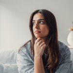 Close up of sad pensive woman sitting alone