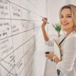 smiling women showing how to organize office for the best production work