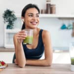 Busy professional woman drinking a smoothie and practicing self care